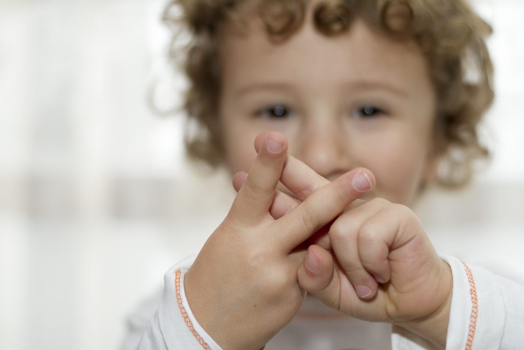 Little boy showing Hashtag sign with hands